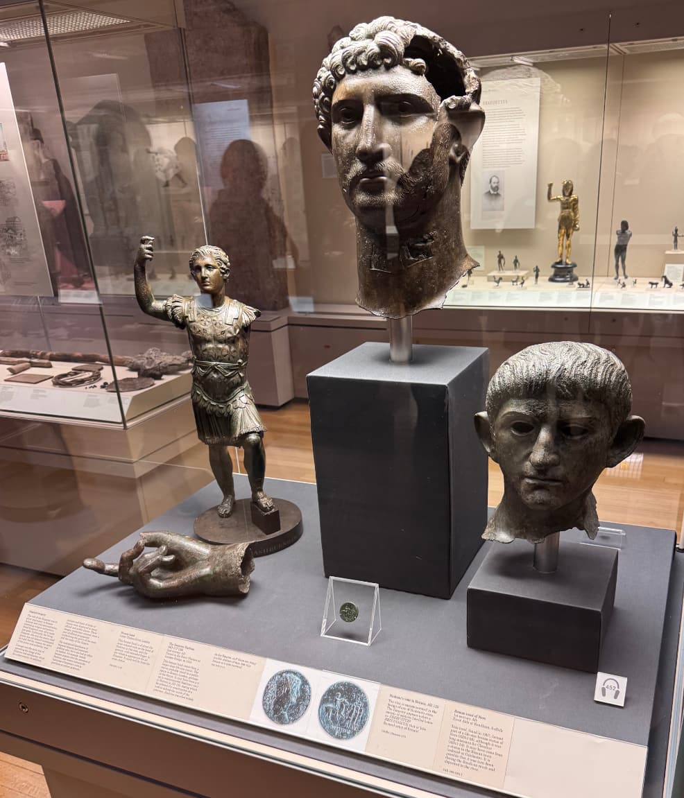 A display with several bronze statues of Roman emperors
