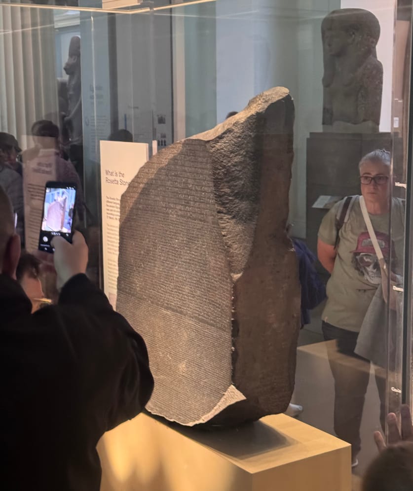 The Rosetta Stone with several people looking at it