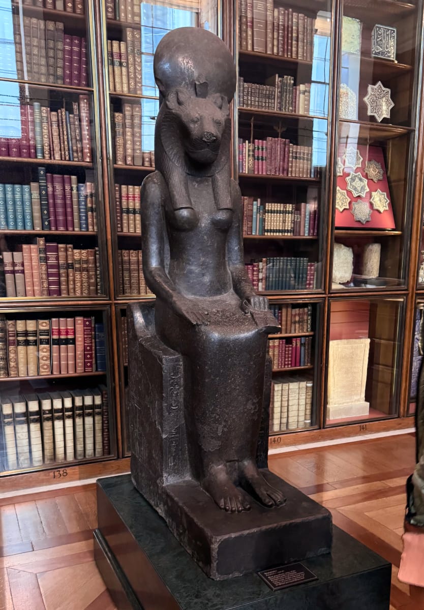 A dark statue of Sekhmet, the Egyptian lion goddess, in the British Museum