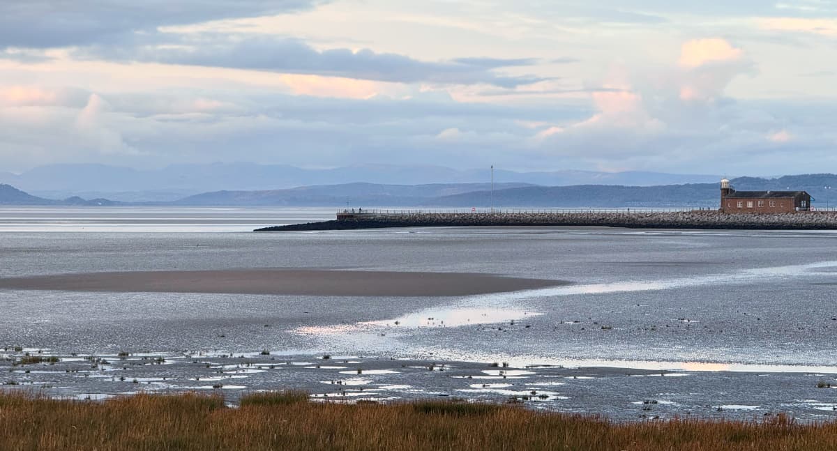 Shoreline and spit before Morecambe Bay and mountains on the horizon.
