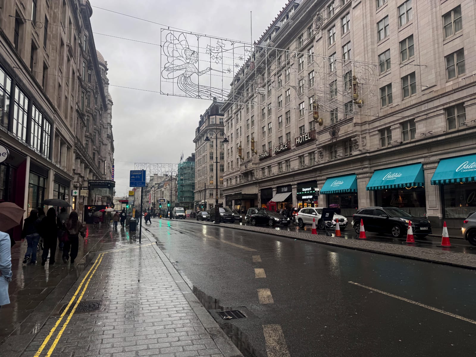 London's Strand, with packed sidewalks and empty car-lanes, except for outside a hotel