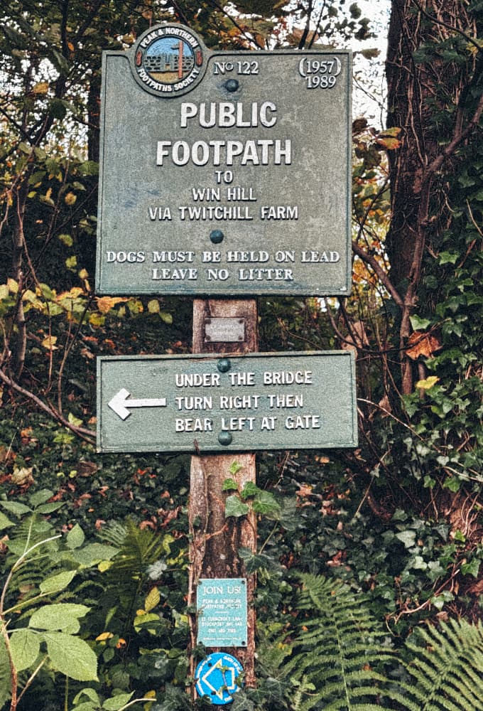 A Peaks and Northern Footpaths Society signs saying 'Public Footpath to Win Hill via Twitchill Farm' Under the Bridge Turn Right Then Bear Left At Gate