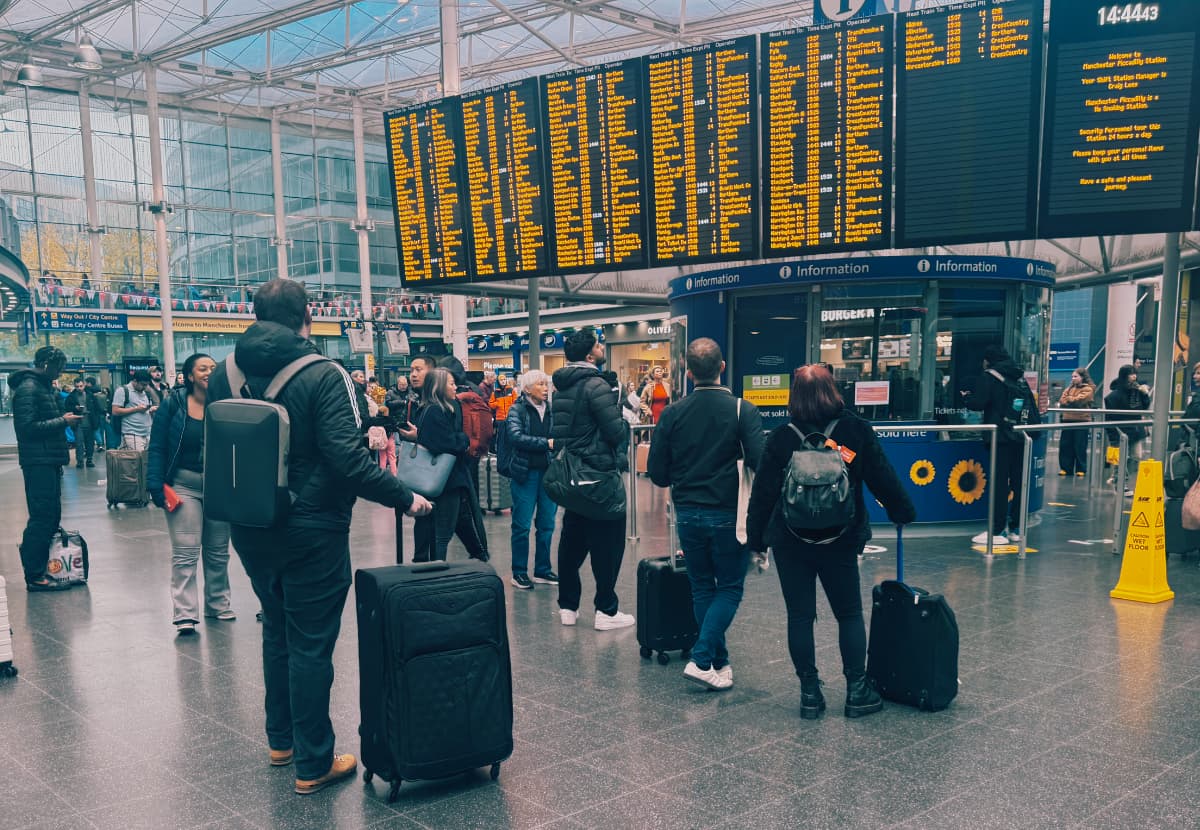 A crowd looking at the schedule board in Manchester Piccadilly station
