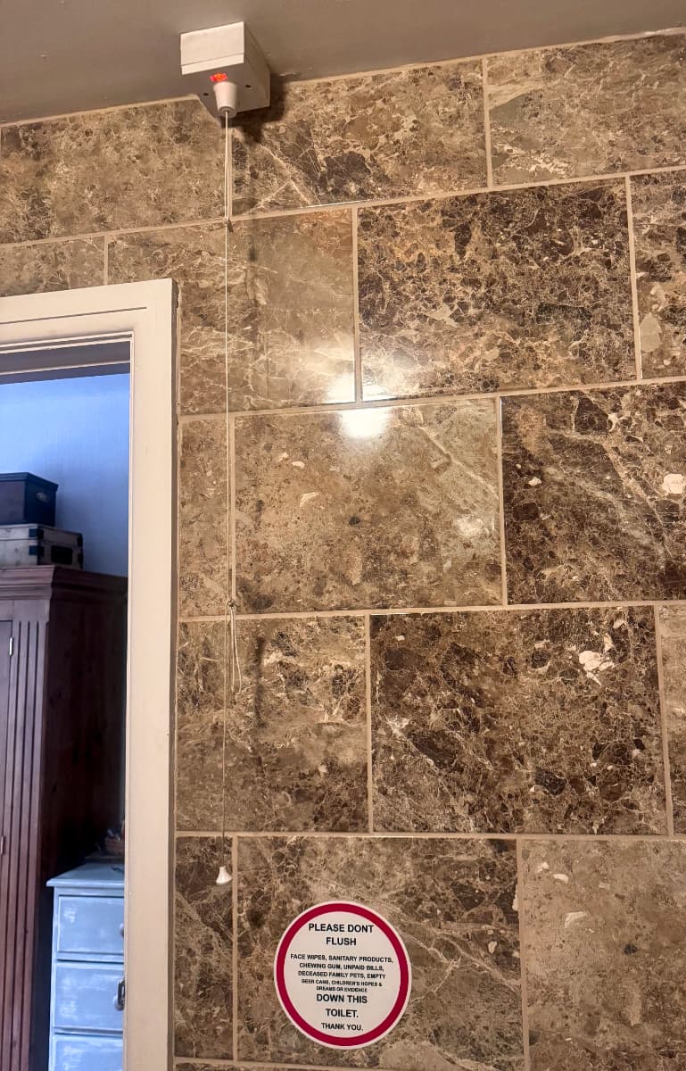 A bathroom power switch activated by a string from the ceiling in a hotel bathroom in the Peak District